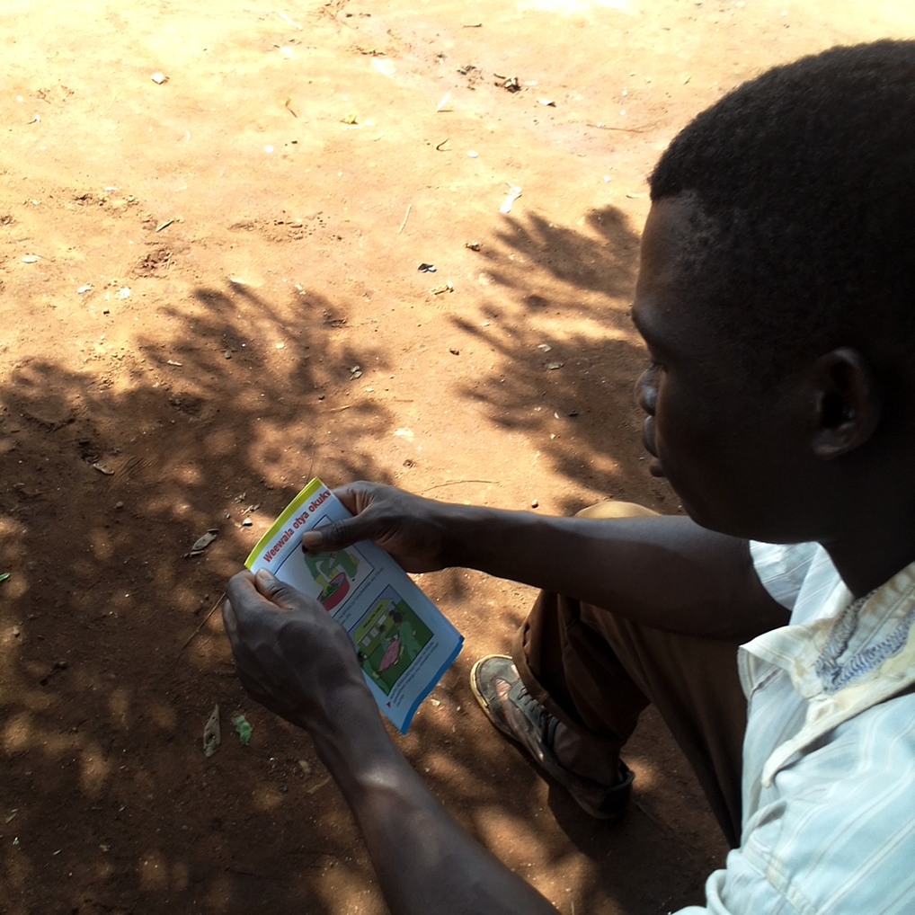 ugandan reading flyer about ebola prevention during outbreak